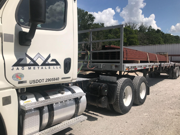 Jag metals flat bed with steel loaded in the trailor.